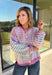 Bring a little extra color to cozy season with this striped knit cardigan from Twenitfourth. A playful mix of pink, purple, coral, blue, lavender, and off white gives this sweater a cheerful look that instantly brightens up cooler days. The button-down front makes it easy to wear closed as a top or open over your favorite tee or tank for a layered look.