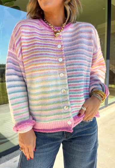 Bring a little extra color to cozy season with this striped knit cardigan from Twenitfourth. A playful mix of pink, purple, coral, blue, lavender, and off white gives this sweater a cheerful look that instantly brightens up cooler days. The button-down front makes it easy to wear closed as a top or open over your favorite tee or tank for a layered look.