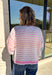 Bring a little extra color to cozy season with this striped knit cardigan from Twenitfourth. A playful mix of pink, purple, coral, blue, lavender, and off white gives this sweater a cheerful look that instantly brightens up cooler days. The button-down front makes it easy to wear closed as a top or open over your favorite tee or tank for a layered look.