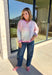Bring a little extra color to cozy season with this striped knit cardigan from Twenitfourth. A playful mix of pink, purple, coral, blue, lavender, and off white gives this sweater a cheerful look that instantly brightens up cooler days. The button-down front makes it easy to wear closed as a top or open over your favorite tee or tank for a layered look.