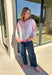 Bring a little extra color to cozy season with this striped knit cardigan from Twenitfourth. A playful mix of pink, purple, coral, blue, lavender, and off white gives this sweater a cheerful look that instantly brightens up cooler days. The button-down front makes it easy to wear closed as a top or open over your favorite tee or tank for a layered look.