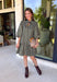 Unexpected color makes this floral dress from Entro such a fun pick for the season. The olive green background is covered in an abstract periwinkle floral print, creating a pretty mix of earthy and cool tones that stands out from traditional fall florals. A shirt collar and self-tie neckline add extra detail, while the button-front closure and ¾ puff sleeves give the silhouette a classic feel. The ruffle hem adds a playful finish, and the lined design provides comfortable coverage.