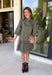 Unexpected color makes this floral dress from Entro such a fun pick for the season. The olive green background is covered in an abstract periwinkle floral print, creating a pretty mix of earthy and cool tones that stands out from traditional fall florals. A shirt collar and self-tie neckline add extra detail, while the button-front closure and ¾ puff sleeves give the silhouette a classic feel. The ruffle hem adds a playful finish, and the lined design provides comfortable coverage.
