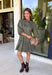 Unexpected color makes this floral dress from Entro such a fun pick for the season. The olive green background is covered in an abstract periwinkle floral print, creating a pretty mix of earthy and cool tones that stands out from traditional fall florals. A shirt collar and self-tie neckline add extra detail, while the button-front closure and ¾ puff sleeves give the silhouette a classic feel. The ruffle hem adds a playful finish, and the lined design provides comfortable coverage.