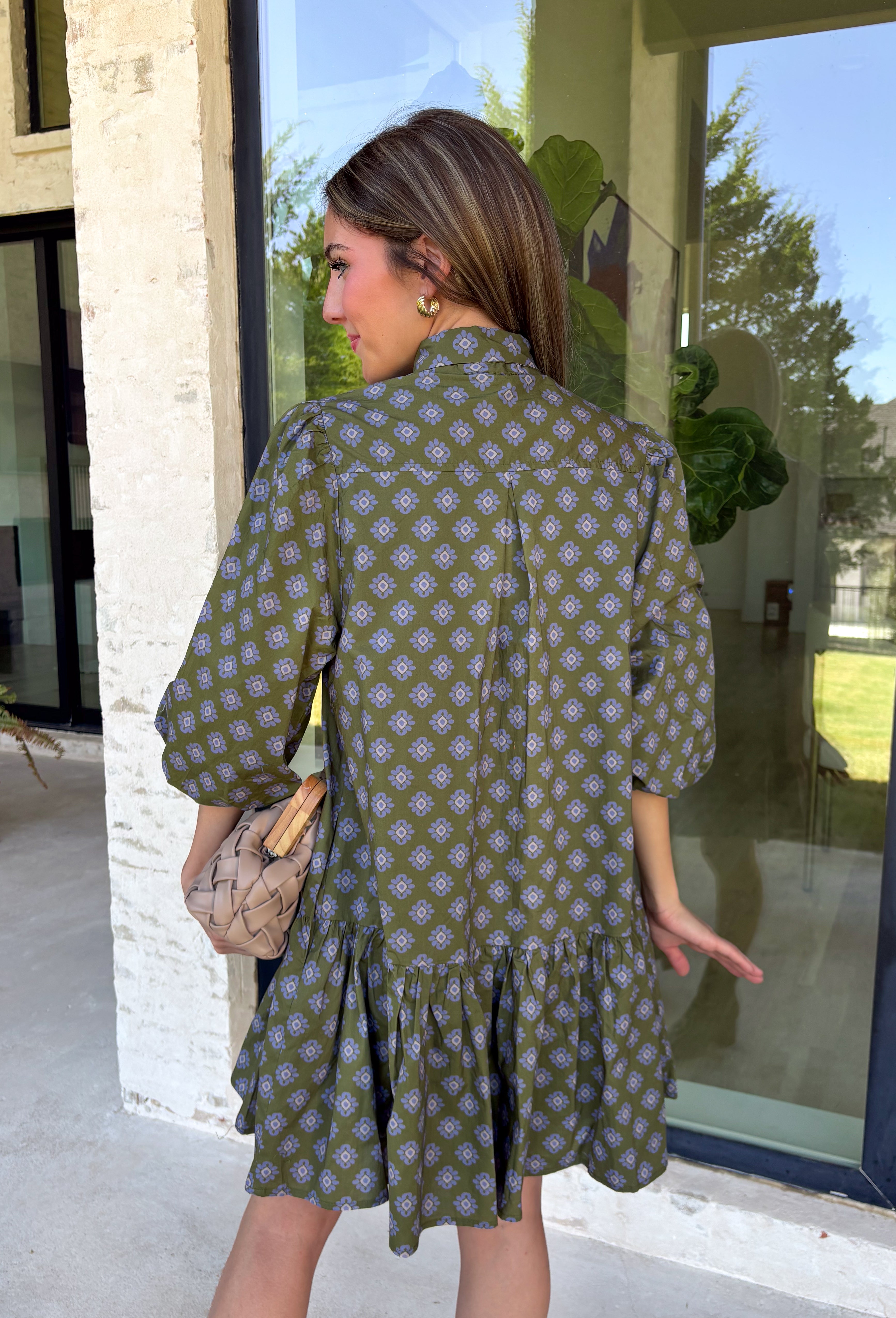 Unexpected color makes this floral dress from Entro such a fun pick for the season. The olive green background is covered in an abstract periwinkle floral print, creating a pretty mix of earthy and cool tones that stands out from traditional fall florals. A shirt collar and self-tie neckline add extra detail, while the button-front closure and ¾ puff sleeves give the silhouette a classic feel. The ruffle hem adds a playful finish, and the lined design provides comfortable coverage.