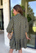 Unexpected color makes this floral dress from Entro such a fun pick for the season. The olive green background is covered in an abstract periwinkle floral print, creating a pretty mix of earthy and cool tones that stands out from traditional fall florals. A shirt collar and self-tie neckline add extra detail, while the button-front closure and ¾ puff sleeves give the silhouette a classic feel. The ruffle hem adds a playful finish, and the lined design provides comfortable coverage.