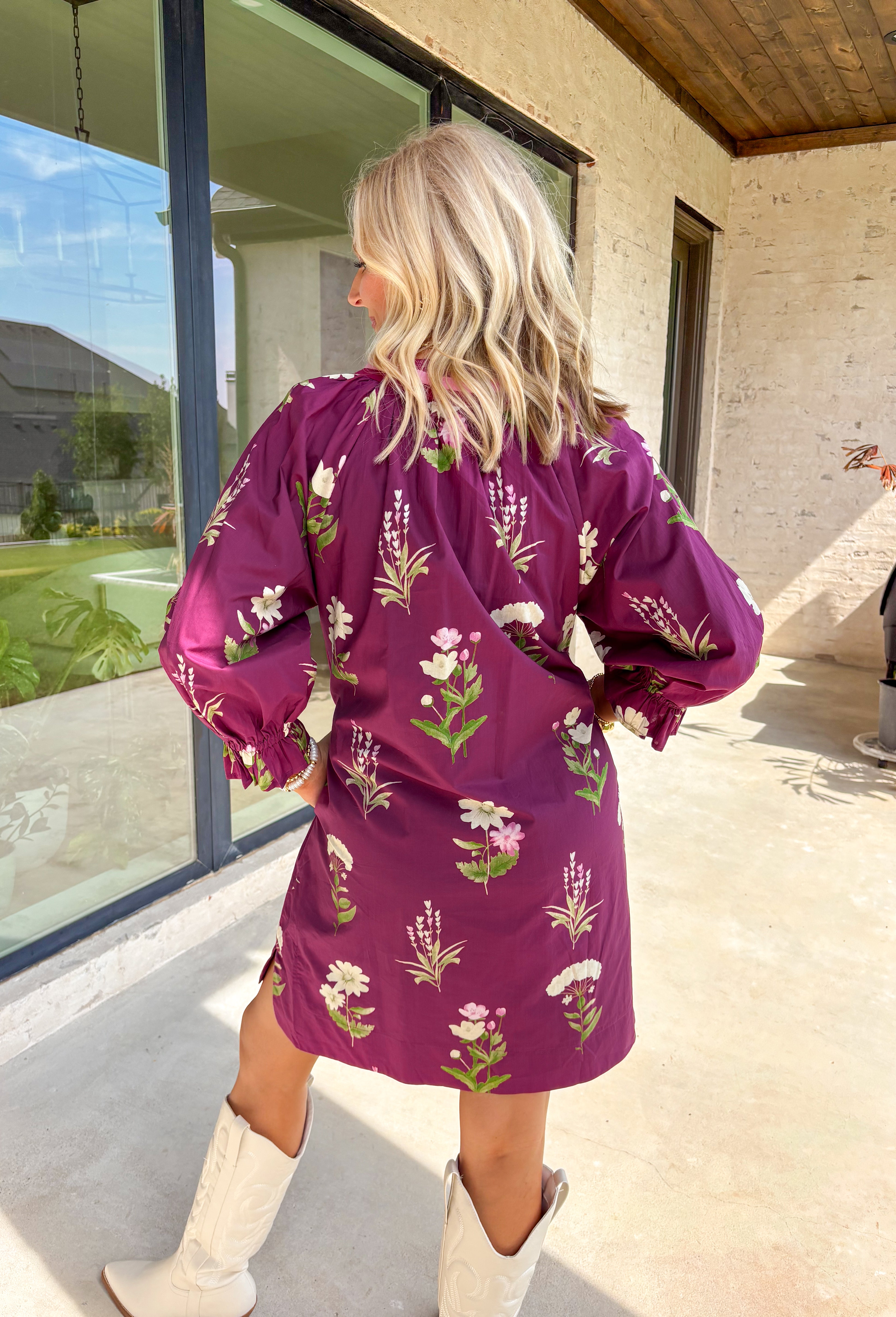 This plum floral dress is giving fall garden party—but make it chic The soft long sleeves are finished with a playful elastic ruffle, while the neutral floral print pops with dreamy shades of cream, pink, and olive. A contrasting trim along the top adds just the right amount of detail. Lined for comfort and style, it’s the kind of dress that goes from pumpkin patch strolls to dinner dates without missing a beat.