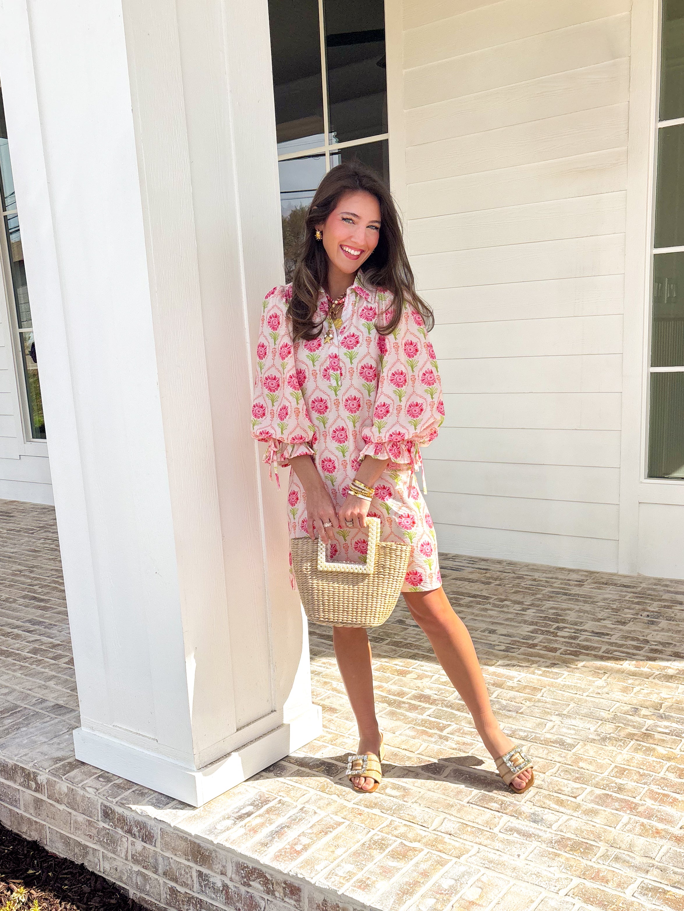 Bright, breezy, and full of spring charm, this off-white dress by Entro is an easy favorite for sunny days ahead. Featuring a colorful floral print with pops of pink, coral, and green, it feels cheerful and perfectly seasonal. The collared neckline adds a classic touch, while the ¾ length sleeves with elastic cuffs and adjustable tie details give it a relaxed, feminine finish. Fully lined for comfortable wear, this dress is effortlessly polished and ready for everything from brunch dates to spring events.