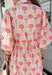 Bright, breezy, and full of spring charm, this off-white dress by Entro is an easy favorite for sunny days ahead. Featuring a colorful floral print with pops of pink, coral, and green, it feels cheerful and perfectly seasonal. The collared neckline adds a classic touch, while the ¾ length sleeves with elastic cuffs and adjustable tie details give it a relaxed, feminine finish. Fully lined for comfortable wear, this dress is effortlessly polished and ready for everything from brunch dates to spring events.