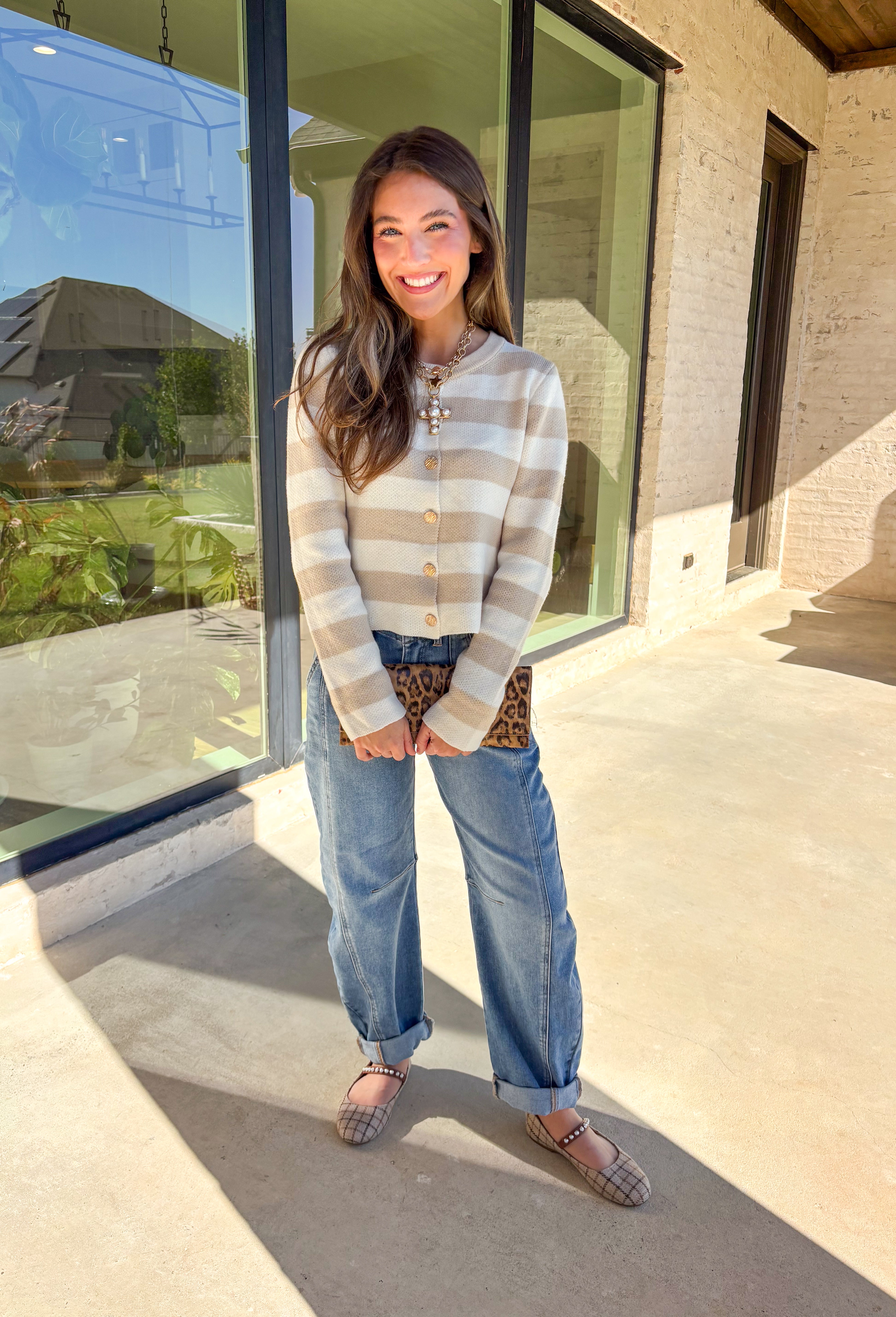 Wrap yourself in cozy-chic comfort with this neutral striped cardigan, designed with a flattering fit and glam gold textured buttons down the front. Whether you're heading into the office or sipping cider on the weekend, this layering piece brings the perfect blend of classic style and a touch of shine. A fall staple that feels as good as it looks!