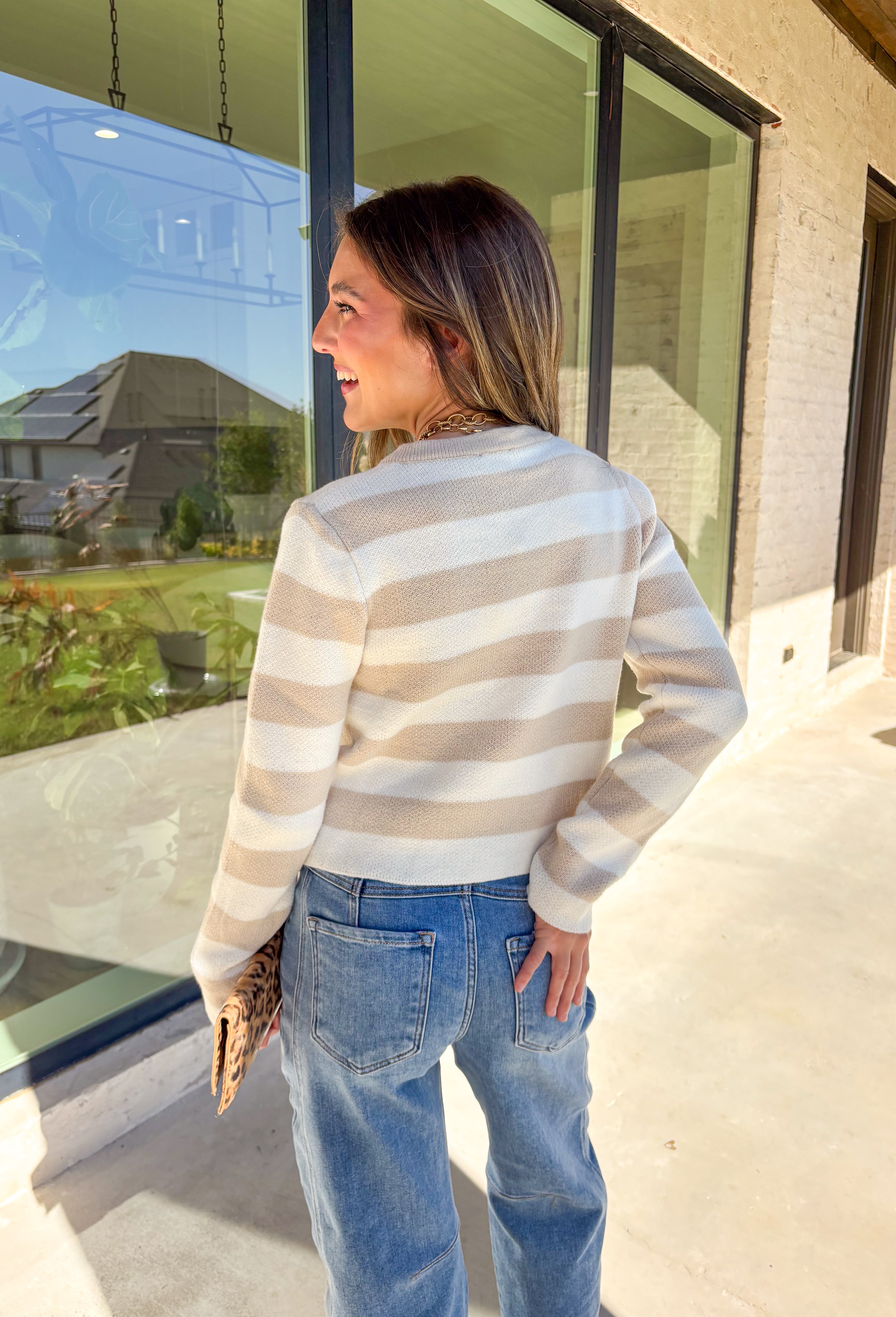Wrap yourself in cozy-chic comfort with this neutral striped cardigan, designed with a flattering fit and glam gold textured buttons down the front. Whether you're heading into the office or sipping cider on the weekend, this layering piece brings the perfect blend of classic style and a touch of shine. A fall staple that feels as good as it looks!