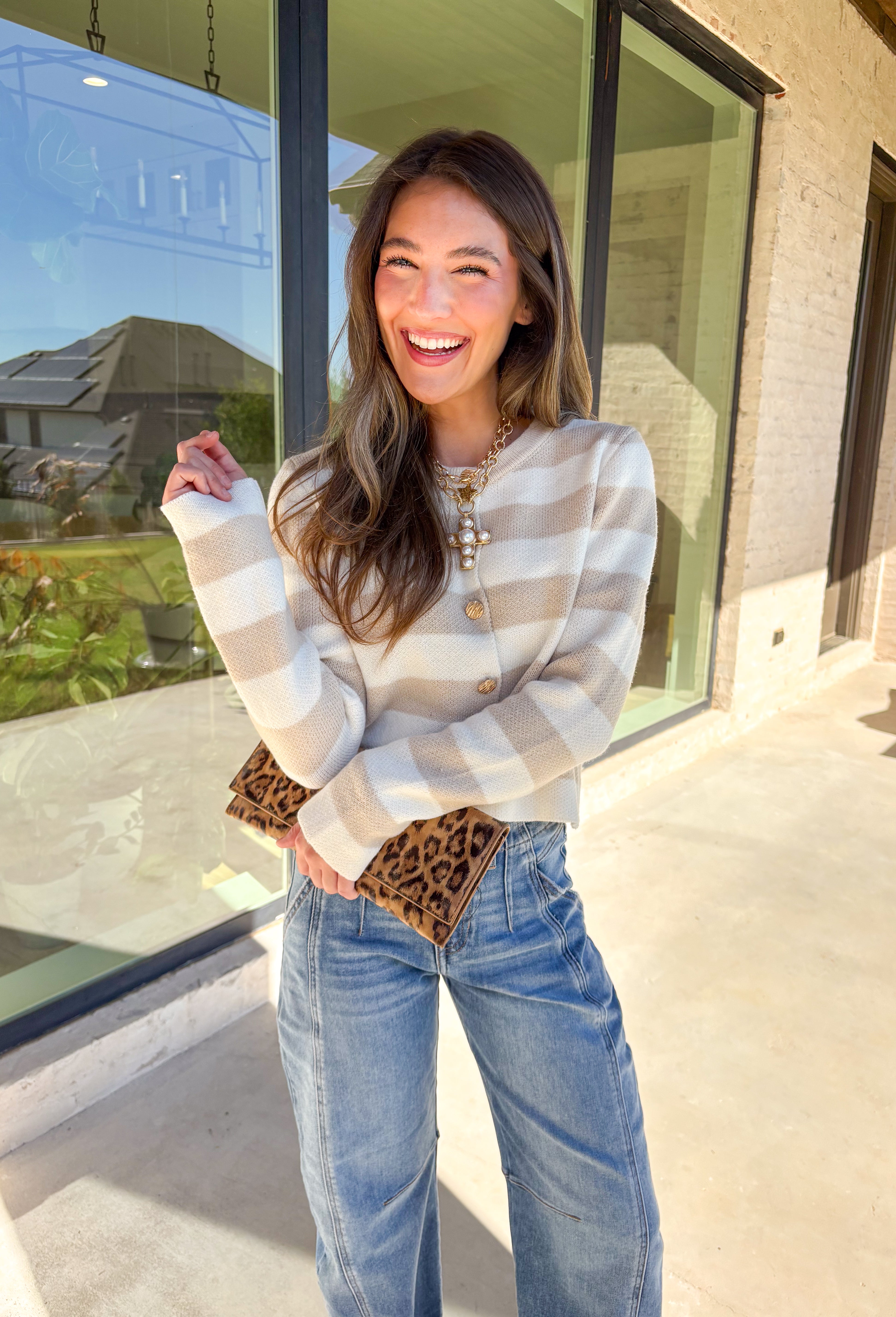 Wrap yourself in cozy-chic comfort with this neutral striped cardigan, designed with a flattering fit and glam gold textured buttons down the front. Whether you're heading into the office or sipping cider on the weekend, this layering piece brings the perfect blend of classic style and a touch of shine. A fall staple that feels as good as it looks!