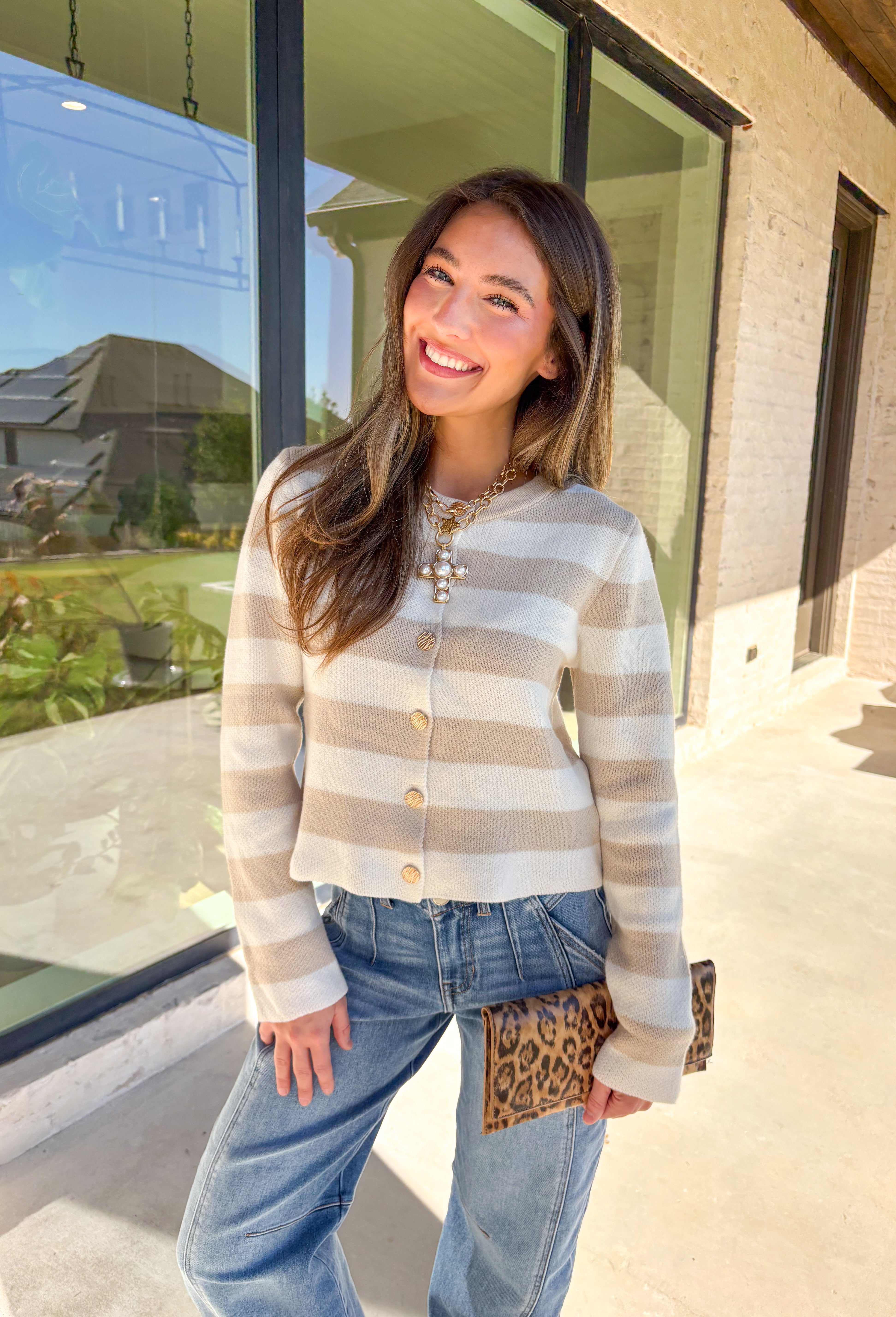 Wrap yourself in cozy-chic comfort with this neutral striped cardigan, designed with a flattering fit and glam gold textured buttons down the front. Whether you're heading into the office or sipping cider on the weekend, this layering piece brings the perfect blend of classic style and a touch of shine. A fall staple that feels as good as it looks!
