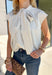 Classic stripes get a fresh update with this cream and black top from Entro. The neutral color combination makes it an easy piece to work into your wardrobe, while the self-tie neckline adds a fun detail that sets it apart from your everyday striped tops. Cap sleeves keep the silhouette light and easy to layer, and a button closure at the back completes the look. From office days with tailored pants to dinner plans with denim, this versatile top makes putting together an outfit feel effortless.