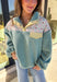Cozy meets fresh in this sage sherpa pullover by New In — the perfect layer for cool spring mornings and breezy evenings. Designed with a soft sherpa body, this pullover features a floral quilted print along the top for a sweet seasonal touch. Pale yellow trim at the quarter button closure and a matching front pocket add a cheerful pop of color, making this piece feel bright, playful, and easy to wear as the seasons change.