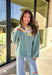 Cozy meets fresh in this sage sherpa pullover by New In — the perfect layer for cool spring mornings and breezy evenings. Designed with a soft sherpa body, this pullover features a floral quilted print along the top for a sweet seasonal touch. Pale yellow trim at the quarter button closure and a matching front pocket add a cheerful pop of color, making this piece feel bright, playful, and easy to wear as the seasons change.