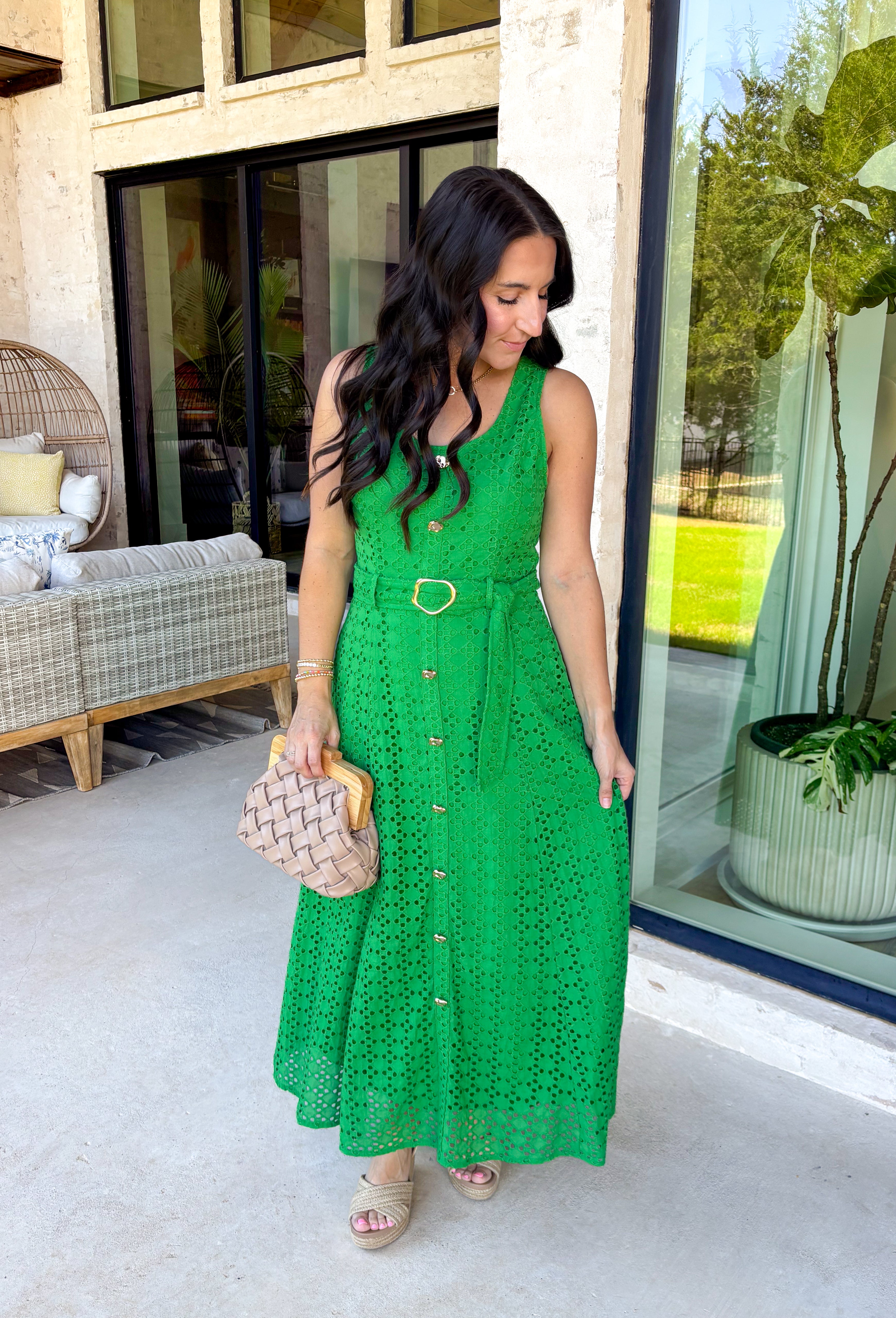Bold, polished, and beautifully detailed — this kelly green eyelet lace midi dress is a true standout. The intricate eyelet lace gives it texture and dimension, while the gold textured button-down front adds a hint of shine that elevates the entire look. Designed with a matching belt featuring a gold buckle, this dress cinches the waist for a flattering, feminine silhouette. Smocking along the back provides comfortable stretch, and the back zipper closure keeps the fit secure and streamlined. 
