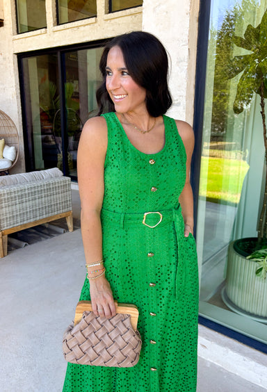 Bold, polished, and beautifully detailed — this kelly green eyelet lace midi dress is a true standout. The intricate eyelet lace gives it texture and dimension, while the gold textured button-down front adds a hint of shine that elevates the entire look. Designed with a matching belt featuring a gold buckle, this dress cinches the waist for a flattering, feminine silhouette. Smocking along the back provides comfortable stretch, and the back zipper closure keeps the fit secure and streamlined. 