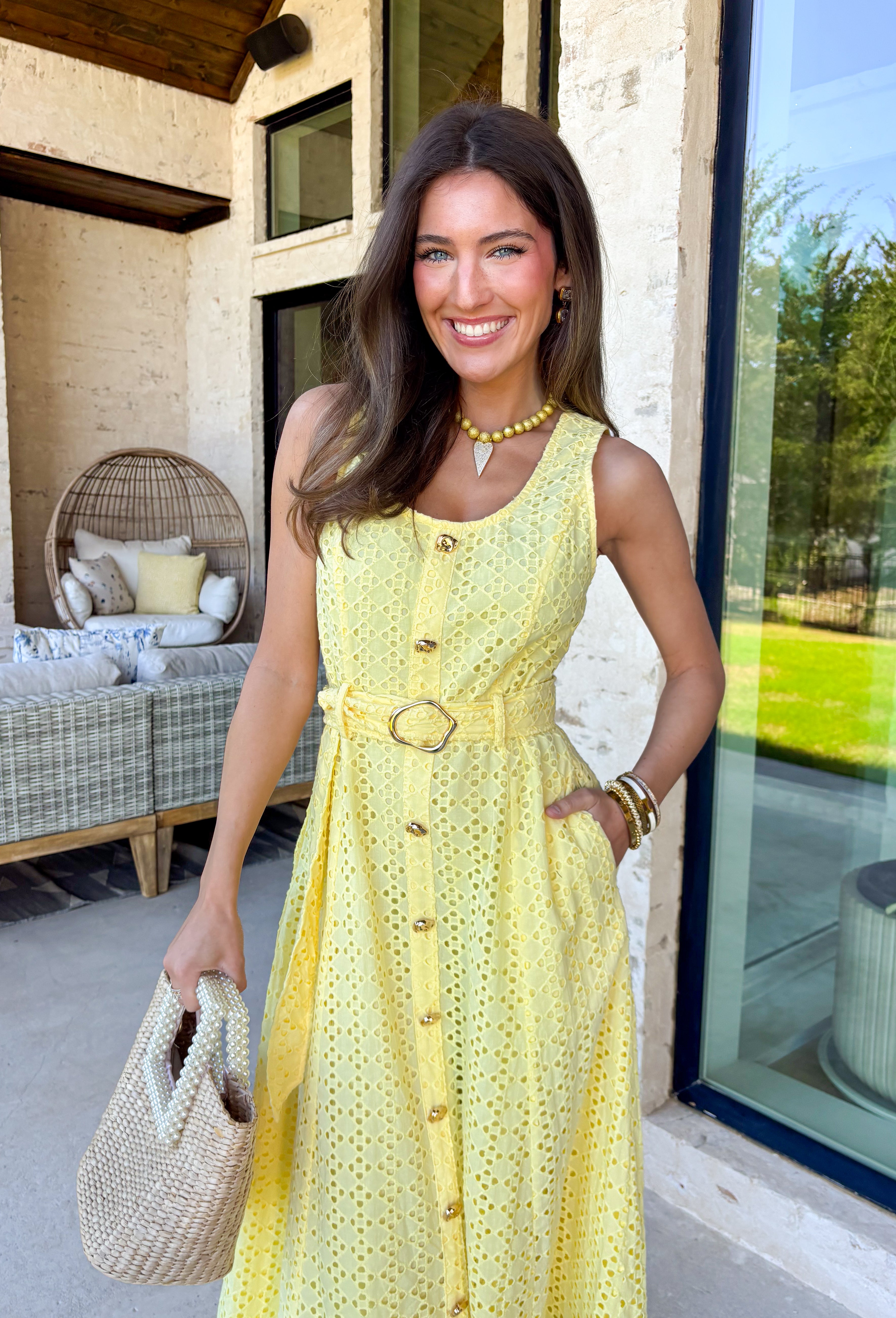Bold, polished, and beautifully detailed — this lemon yellow eyelet lace midi dress is a true standout. The intricate eyelet lace gives it texture and dimension, while the gold textured button-down front adds a hint of shine that elevates the entire look. Designed with a matching belt featuring a gold buckle, this dress cinches the waist for a flattering, feminine silhouette. Smocking along the back provides comfortable stretch, and the back zipper closure keeps the fit secure and streamlined. 