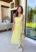 Bold, polished, and beautifully detailed — this lemon yellow eyelet lace midi dress is a true standout. The intricate eyelet lace gives it texture and dimension, while the gold textured button-down front adds a hint of shine that elevates the entire look. Designed with a matching belt featuring a gold buckle, this dress cinches the waist for a flattering, feminine silhouette. Smocking along the back provides comfortable stretch, and the back zipper closure keeps the fit secure and streamlined. 