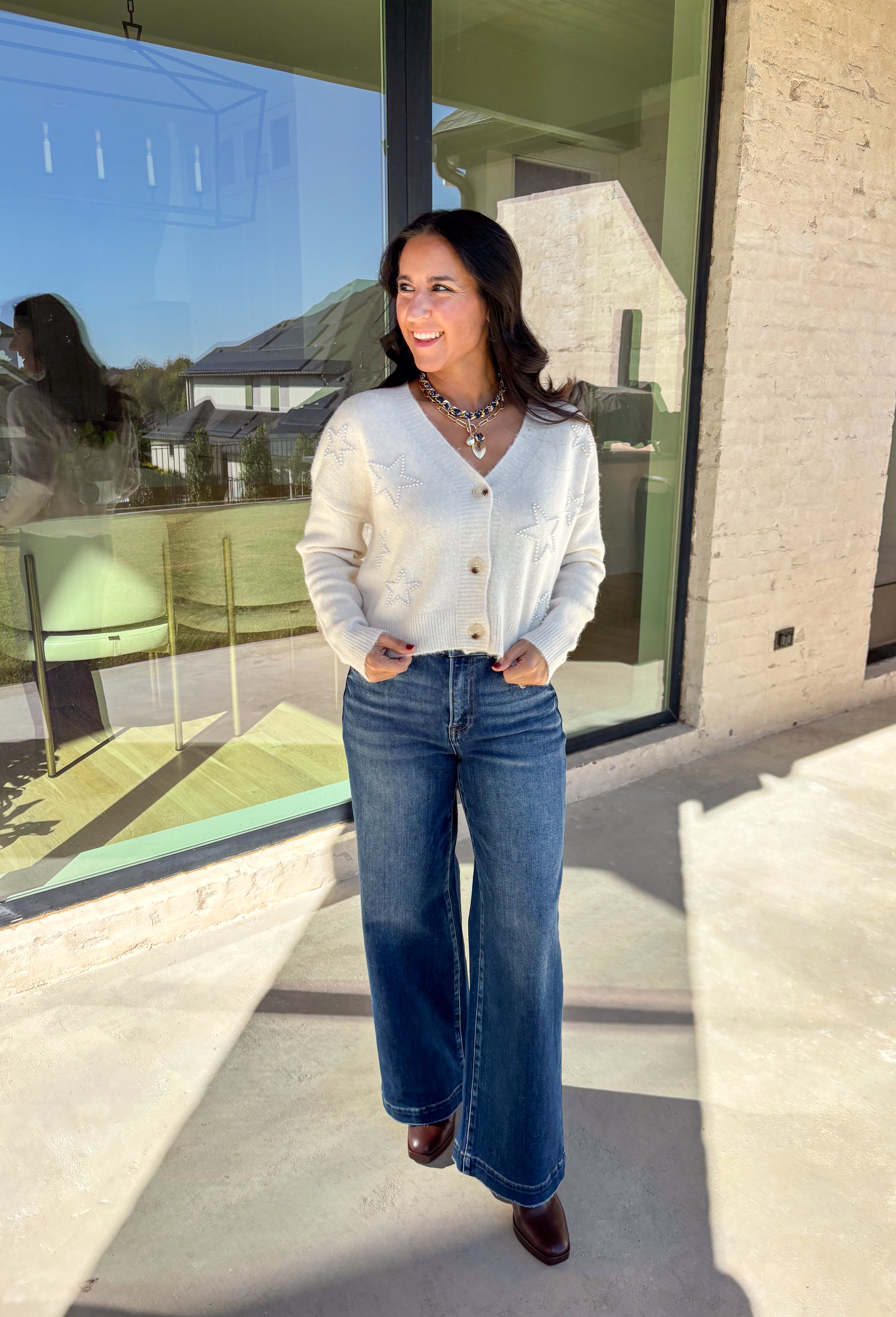 Shine bright this season in this off-white button-down cardigan by Debut. Crafted from a soft, cozy knit, this sweater features delicate pearl star embellishments that add the perfect hint of glam. With its relaxed fit and timeless charm, it’s a dreamy layer for holiday gatherings or casual winter days.