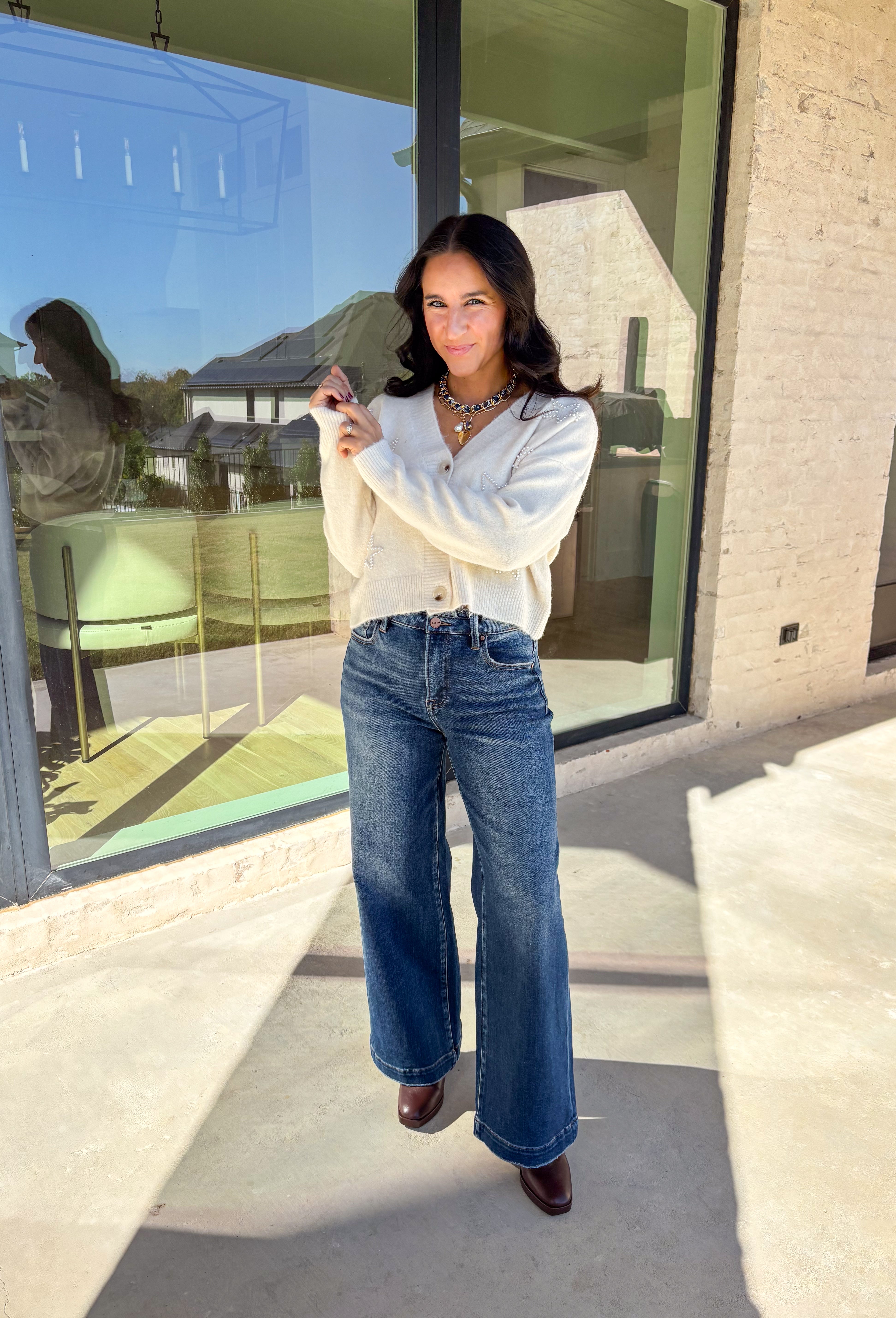 Shine bright this season in this off-white button-down cardigan by Debut. Crafted from a soft, cozy knit, this sweater features delicate pearl star embellishments that add the perfect hint of glam. With its relaxed fit and timeless charm, it’s a dreamy layer for holiday gatherings or casual winter days.