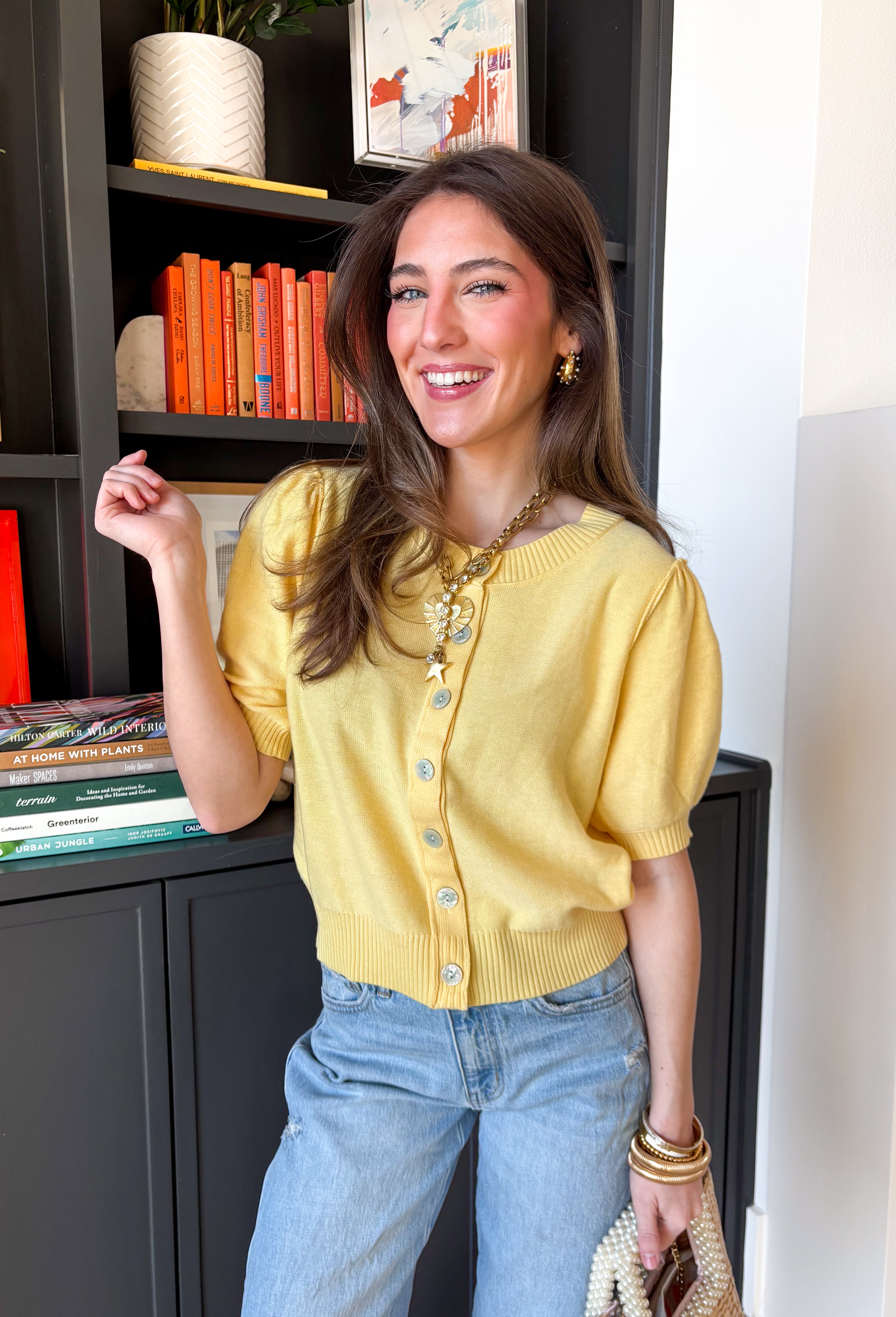 Soft, sunny, and perfect for spring layering, this butter yellow button-down knit top by Entro brings a warm pop of color to your everyday wardrobe. The lightweight knit feels cozy without being heavy, making it ideal for those in-between spring days. Ribbed detailing along the neckline, cuffs, and hem adds subtle texture and a polished finish, while the button-down design makes it easy to wear on its own or layered over a tank.