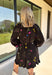 Feminine, chic, and full of seasonal charm, this floral dress is the perfect piece for all your favorite fall occasions. Featuring a classic black backdrop with a vibrant colorful floral print, this dress offers a timeless silhouette with eye-catching details. The flattering v-neckline is accented by a beautiful scarf tie that adds a polished, sophisticated touch, while the self-tie waist creates a customizable fit you'll love. 