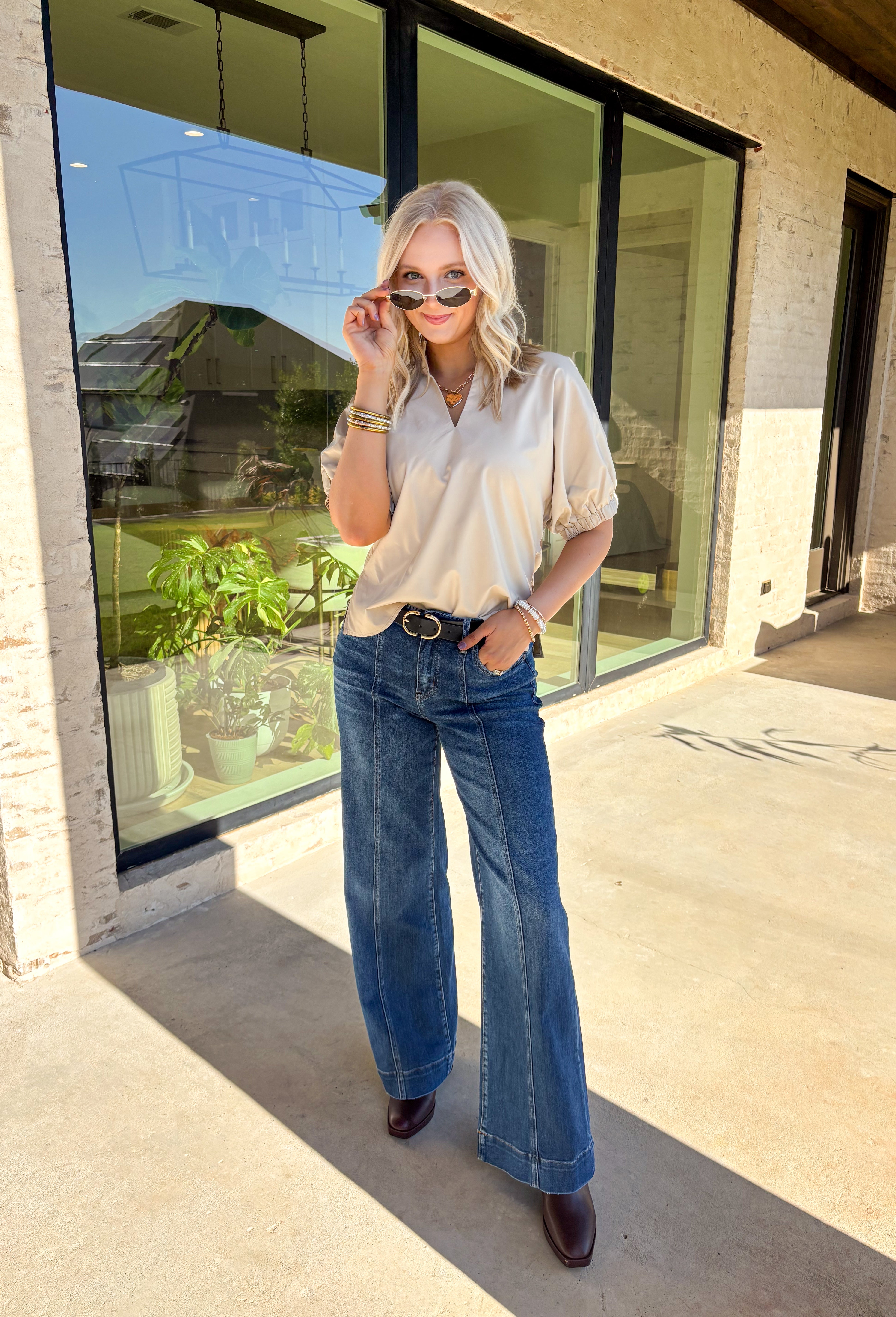 Elevate your wardrobe with this chic ecru faux leather top by Entro. Designed with short puff sleeves and elasticated openings, it strikes the perfect balance of structured and feminine. The split v-neckline with a stand collar adds a modern edge, while the soft faux leather finish brings a touch of texture that feels fresh for the season. Perfect for dressing up denim or pairing with skirts, this top is a statement piece you’ll reach for again and again.