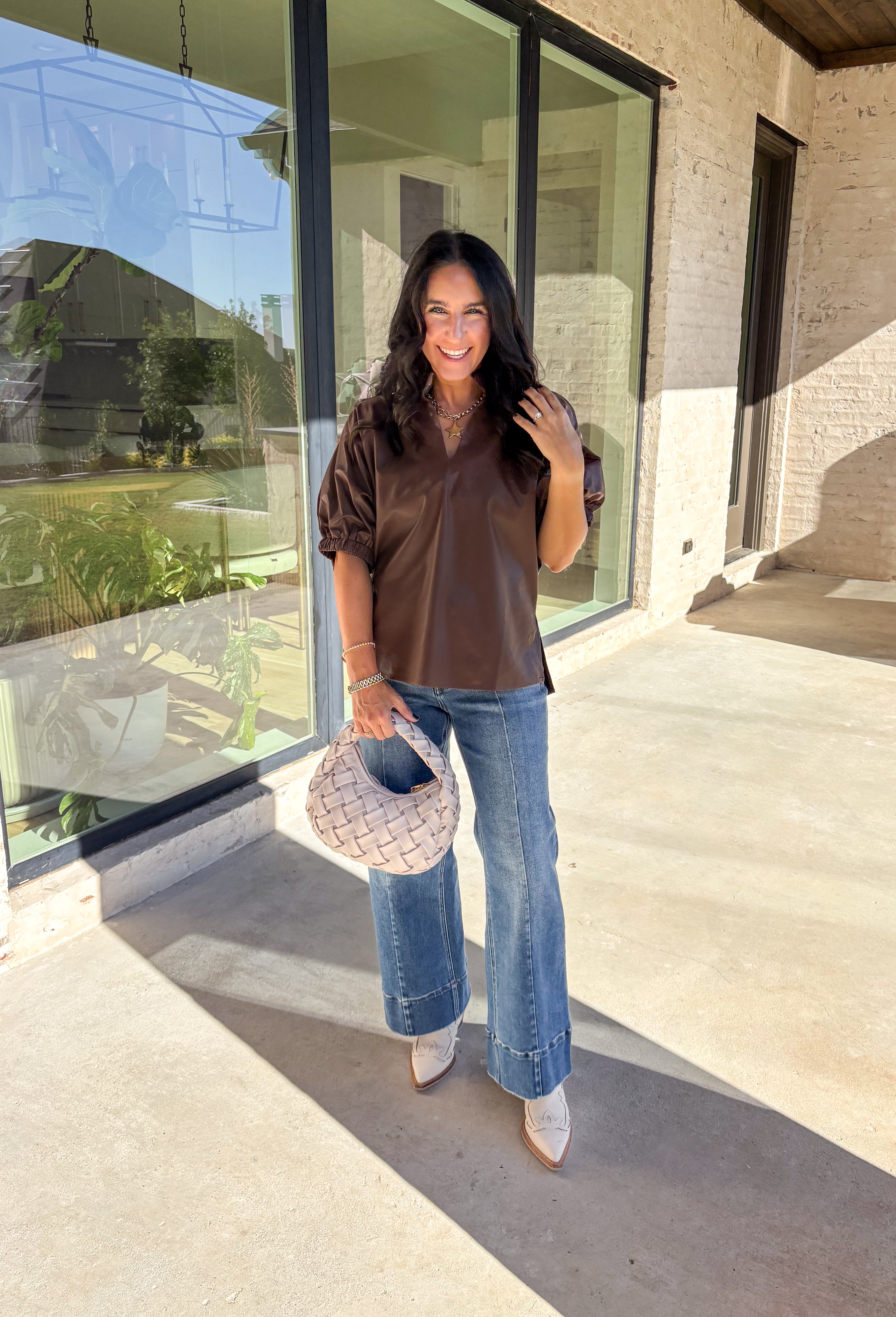 Elevate your wardrobe with this chic brown faux leather top by Entro. Designed with short puff sleeves and elasticated openings, it strikes the perfect balance of structured and feminine. The split v-neckline with a stand collar adds a modern edge, while the soft faux leather finish brings a touch of texture that feels fresh for the season. Perfect for dressing up denim or pairing with skirts, this top is a statement piece you’ll reach for again and again.