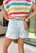 Easy, relaxed, and perfect for sunny days! These light wash high-rise denim shorts feature a subtle white pinstripe print for a fresh, slightly elevated take on a classic staple. The soft stripe detail adds just the right amount of interest while still keeping them easy to style. Designed with an elastic waistband and adjustable tie detail, these shorts are as comfortable as they are cute. 