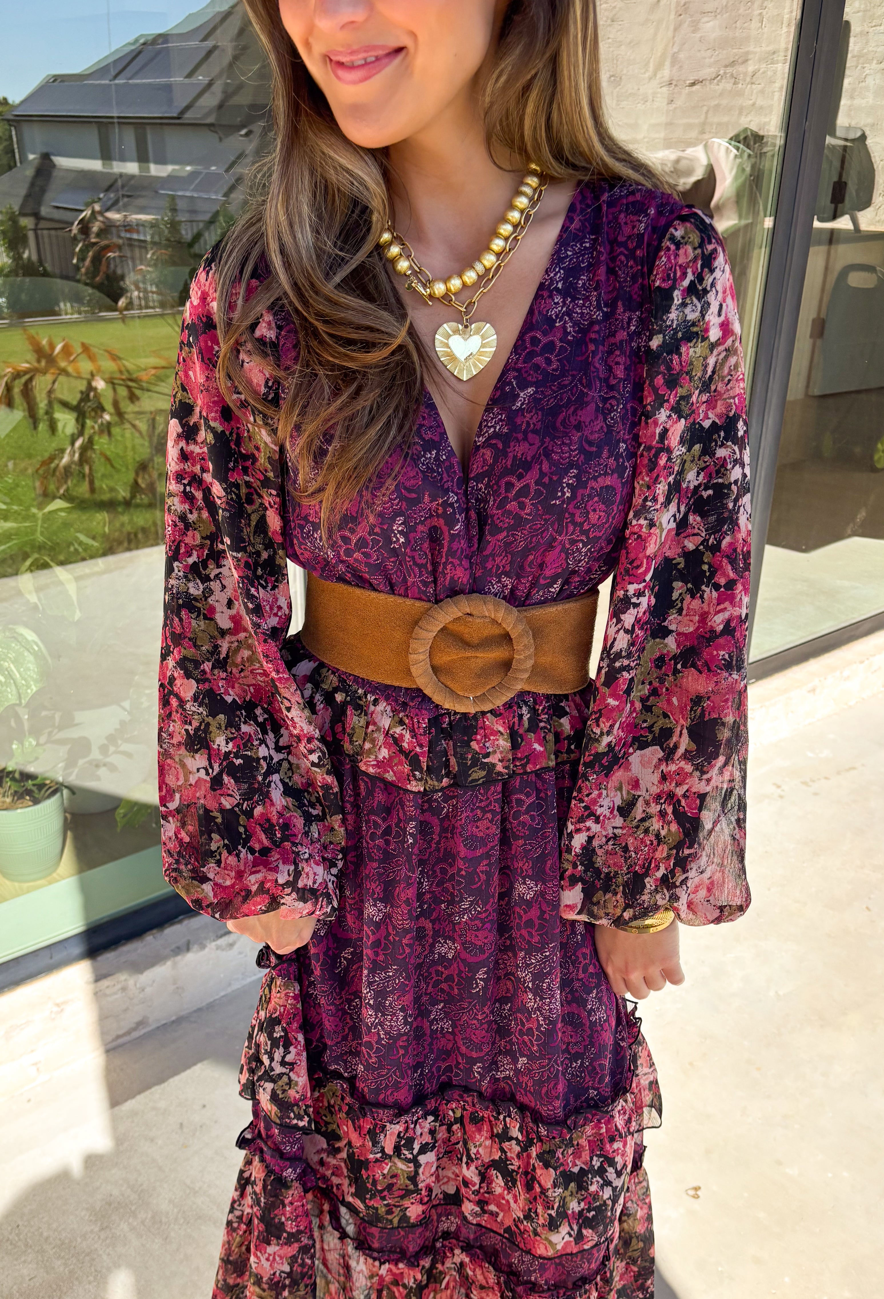 Romantic and striking, this midi dress by Mystree is full of seasonal charm. Crafted in a rich dark purple with a monochromatic floral print, it’s accented by black sleeves featuring a pink floral pattern for a chic contrast. The same floral design is carried through with delicate ruffle detailing, while subtle gold shimmer threading adds a touch of elegance. Finished with an elastic waist and sleeves for comfort, plus a full lining, this dress is as wearable as it is eye-catching.