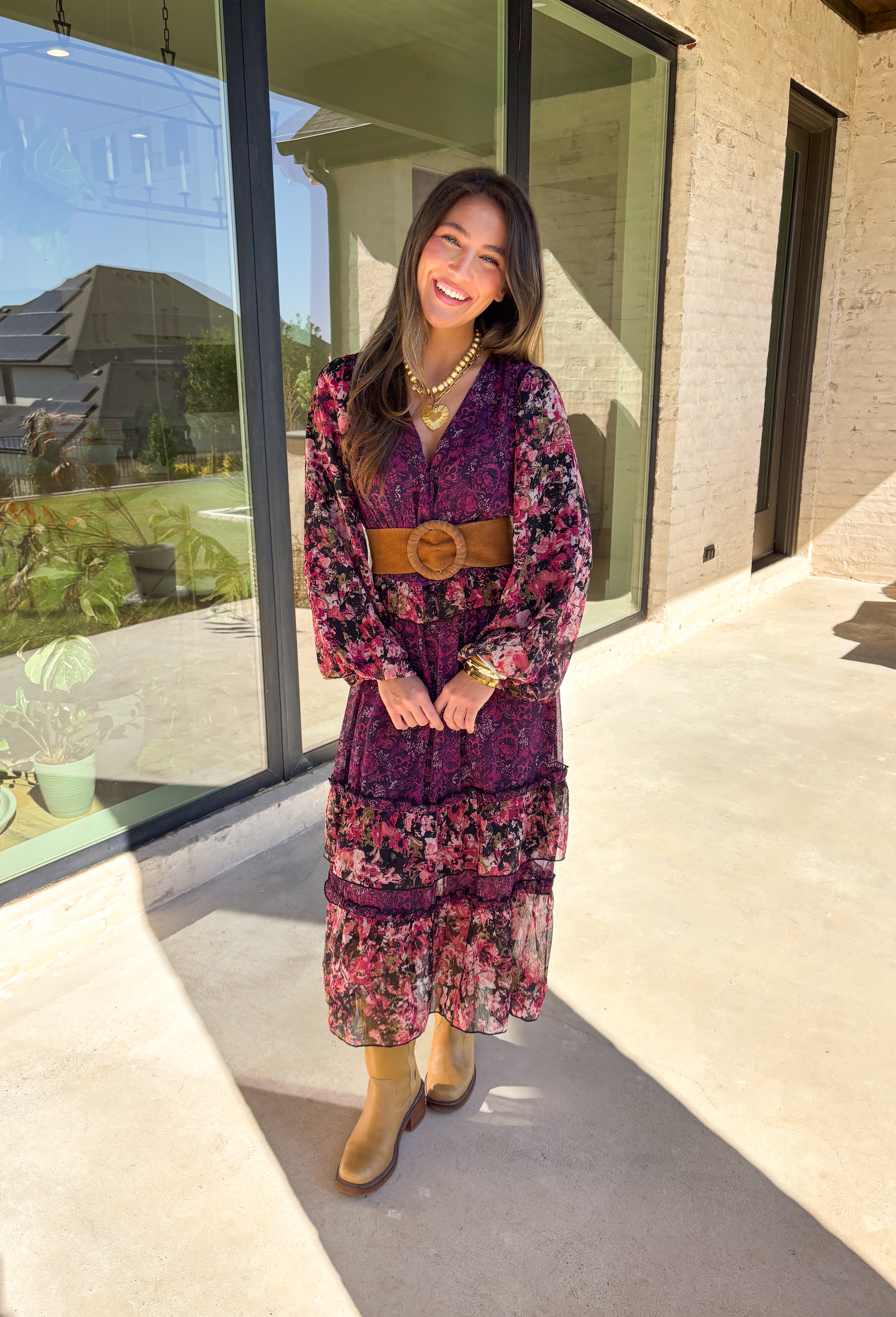 Romantic and striking, this midi dress by Mystree is full of seasonal charm. Crafted in a rich dark purple with a monochromatic floral print, it’s accented by black sleeves featuring a pink floral pattern for a chic contrast. The same floral design is carried through with delicate ruffle detailing, while subtle gold shimmer threading adds a touch of elegance. Finished with an elastic waist and sleeves for comfort, plus a full lining, this dress is as wearable as it is eye-catching.