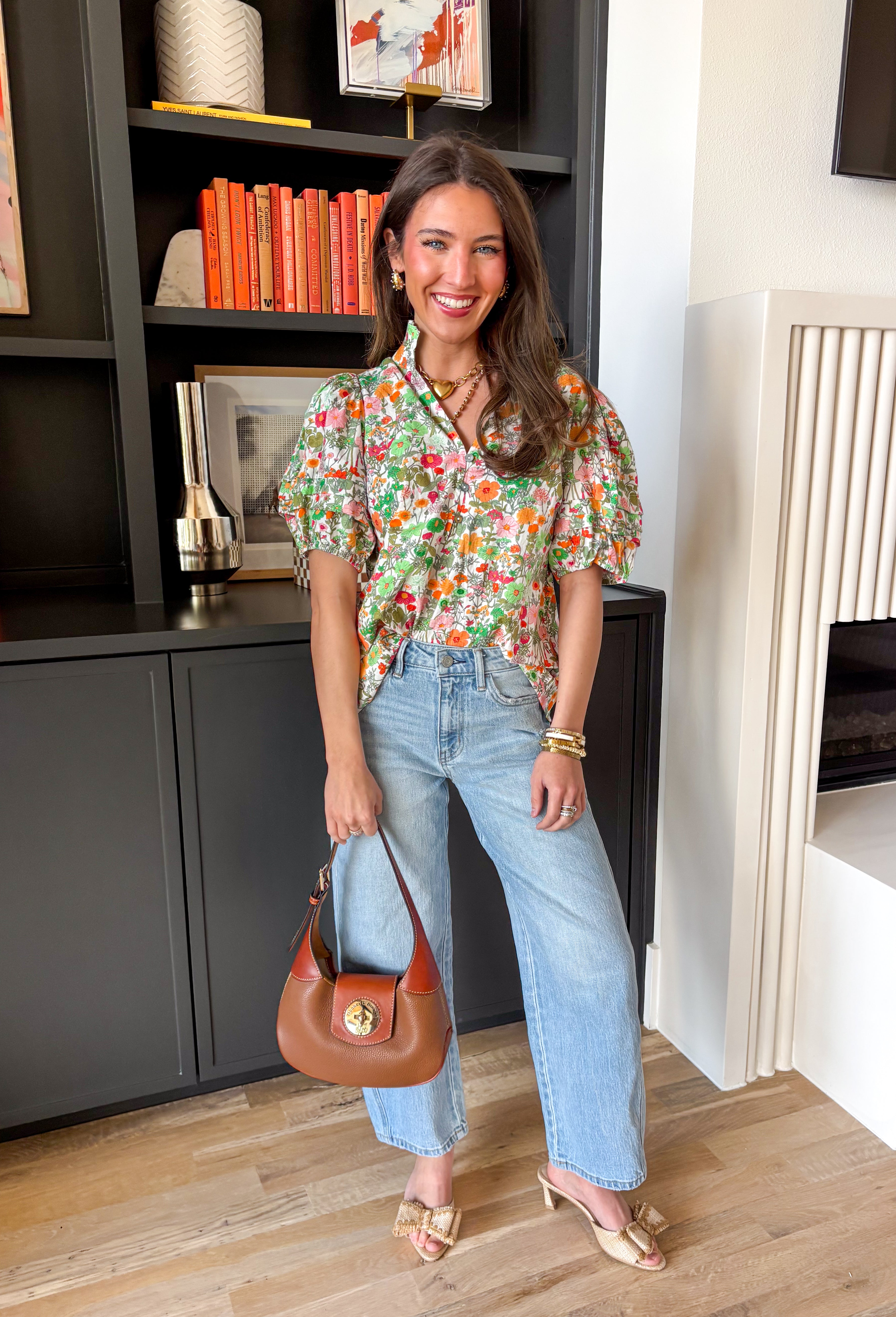 Bright, fresh, and full of spring charm, this white short sleeve top by Entro is the perfect way to add a little color to your everyday look. The colorful floral print features happy pops of orange, green, and pink, while the subtle ruffle neckline keeps it sweet and feminine. Finished with pleated sleeve details and elastic cuffs, it has that “cute but still comfy” vibe we all love.
