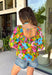 This green floral top is bursting with color and made for sunny summer days! Featuring a vibrant floral print in shades of pink, red, yellow, and blue, it instantly brightens up any outfit. The square neckline gives it a flattering, feminine feel, while the puff sleeves add just the right amount of charm. Finished with a sweet tie detail in the back, this lightweight cotton top is perfect for everything from brunch dates to weekend getaways. 