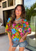 This green floral top is bursting with color and made for sunny summer days! Featuring a vibrant floral print in shades of pink, red, yellow, and blue, it instantly brightens up any outfit. The square neckline gives it a flattering, feminine feel, while the puff sleeves add just the right amount of charm. Finished with a sweet tie detail in the back, this lightweight cotton top is perfect for everything from brunch dates to weekend getaways. 