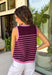 This striped sleeveless sweater is the perfect way to welcome sweater weather! Featuring rich burgundy and pink stripes, it captures all the cozy charm of the season while remaining lightweight enough for those in-between fall days. The contrast trim adds a polished finish, and the classic round neckline makes it easy to wear on its own or layered under your favorite denim jacket, blazer, or cardigan. 