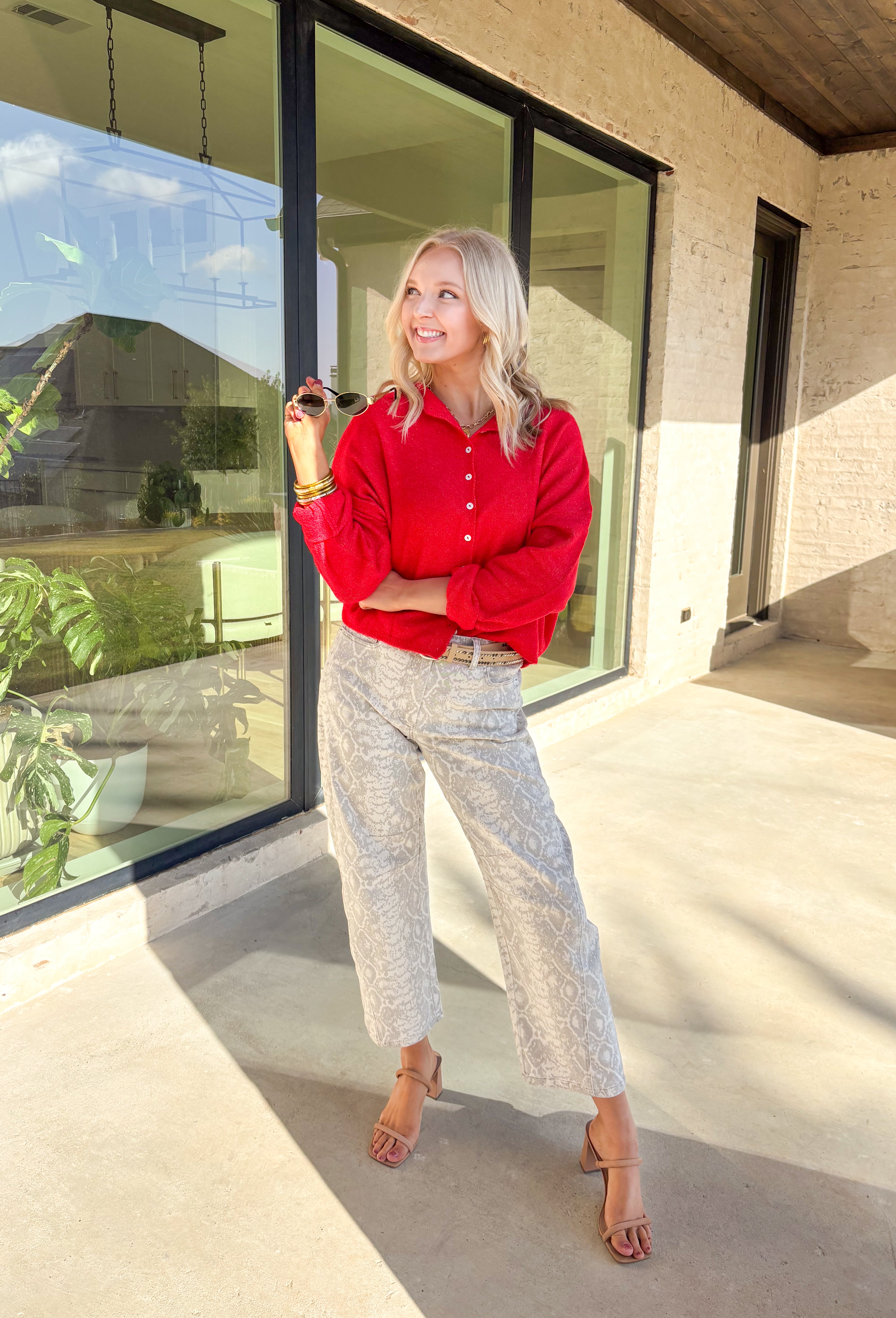 Wrap yourself in cozy holiday charm with this classic red cardigan by Things Between. Featuring a soft knit texture and timeless button-down design, this piece is perfect for layering through the festive season. Its rich red hue makes it a cheerful go-to for holiday gatherings, cozy nights in, or a casual winter day out.