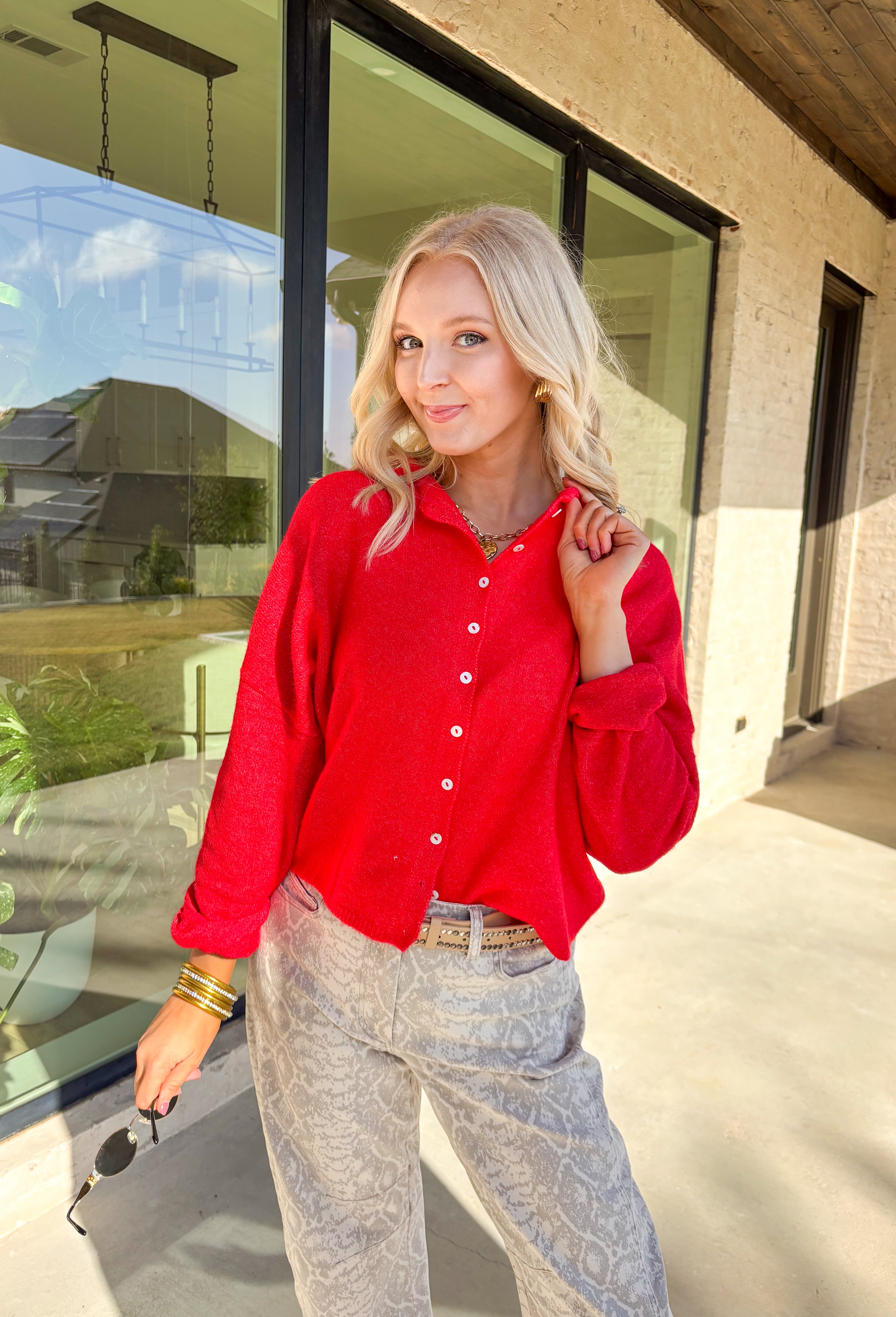 Wrap yourself in cozy holiday charm with this classic red cardigan by Things Between. Featuring a soft knit texture and timeless button-down design, this piece is perfect for layering through the festive season. Its rich red hue makes it a cheerful go-to for holiday gatherings, cozy nights in, or a casual winter day out.