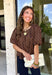 Classic polka dots never go out of style, and this charming top from Day + Moon is the perfect addition to your fall wardrobe. Designed in a rich brown hue with a timeless tan polka dot print, this effortlessly feminine blouse is easy to dress up or down. The puff sleeves add a soft, romantic touch, while the keyhole button closure at the back creates a polished finishing detail. Crafted from breathable cotton, this versatile top is perfect for everything from workdays to weekend outings.