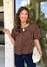 Classic polka dots never go out of style, and this charming top from Day + Moon is the perfect addition to your fall wardrobe. Designed in a rich brown hue with a timeless tan polka dot print, this effortlessly feminine blouse is easy to dress up or down. The puff sleeves add a soft, romantic touch, while the keyhole button closure at the back creates a polished finishing detail. Crafted from breathable cotton, this versatile top is perfect for everything from workdays to weekend outings.