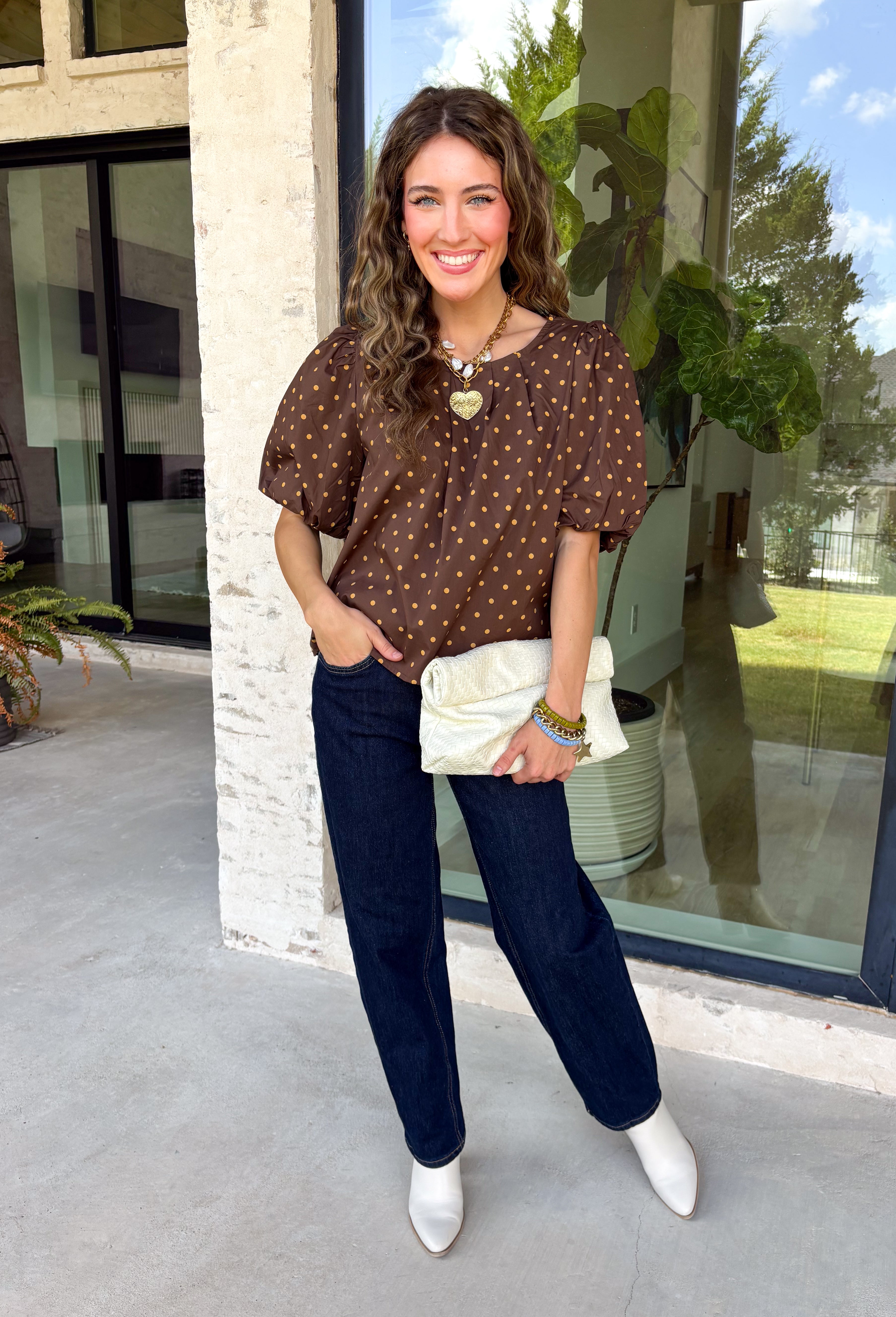 Classic polka dots never go out of style, and this charming top from Day + Moon is the perfect addition to your fall wardrobe. Designed in a rich brown hue with a timeless tan polka dot print, this effortlessly feminine blouse is easy to dress up or down. The puff sleeves add a soft, romantic touch, while the keyhole button closure at the back creates a polished finishing detail. Crafted from breathable cotton, this versatile top is perfect for everything from workdays to weekend outings.