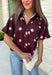 Classic polka dots meet rich fall color in this charming burgundy top! Featuring a soft mauve polka dot print, this top is an effortless way to add personality to your everyday wardrobe. The hidden button front creates a clean, polished look, while the foldover neckline and front pocket add timeless details you'll love. Finished with short puff sleeves, this versatile top is perfect for everything from workdays to weekend brunches and pairs beautifully with your favorite fall denim.