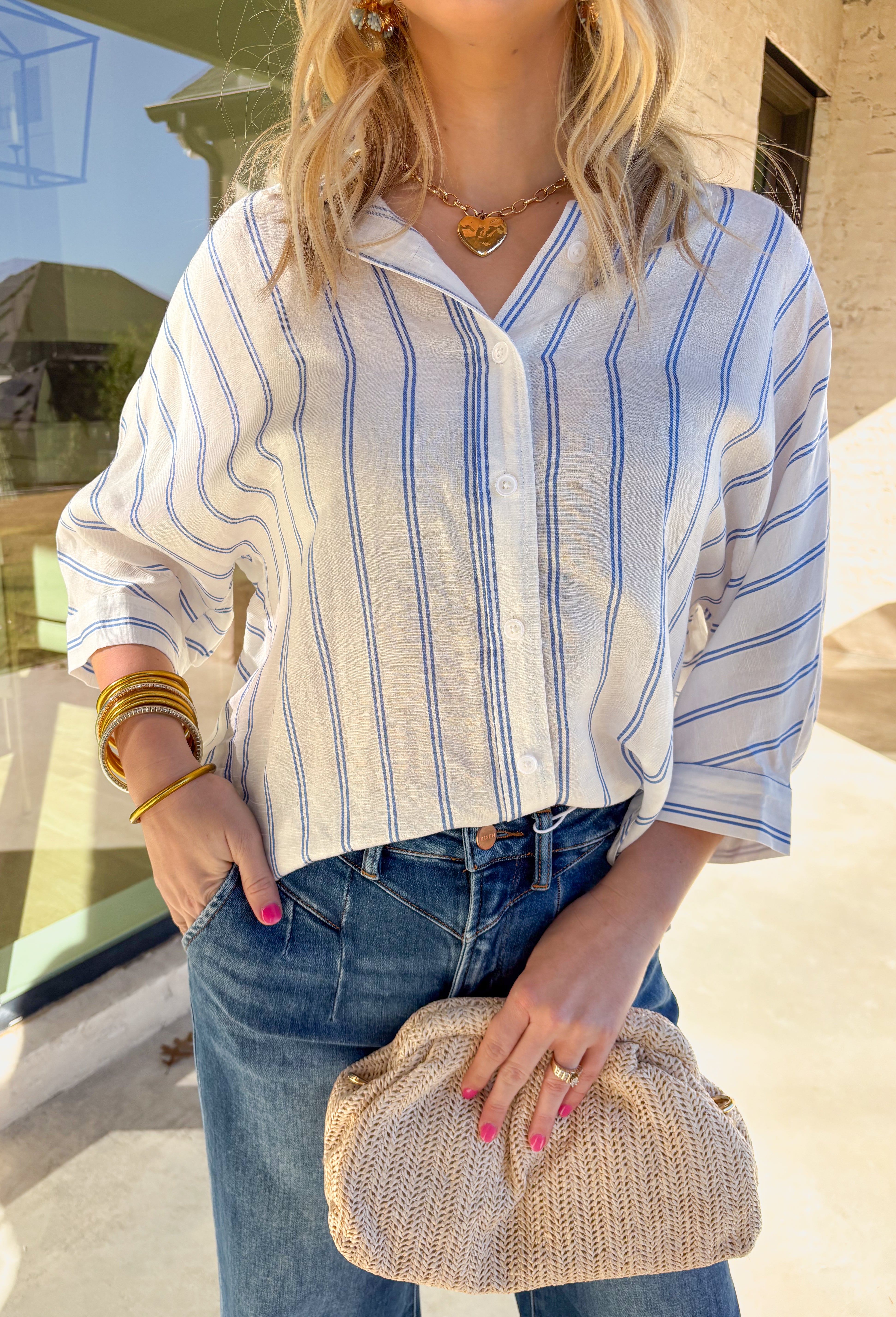 Crisp, classic, and effortlessly cool, this white button-down top by Star Drop is a spring staple you’ll wear on repeat. Featuring blue stripe detailing and a relaxed oversized fit, it has that timeless, borrowed-from-the-boys feel—lightened up for warmer days. The breathable linen blend keeps things airy, while the collared neckline and 3/4 length sleeves make it easy to dress up or down all season long.