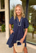 You can never go wrong with classic navy and white polka dots! This dress brings timeless charm with a playful twist. Designed with layered short puff sleeves and elasticated openings, it has just the right amount of volume while staying comfortable and easy to wear. The flattering v-neckline with a collar adds a polished touch, while the elasticated back waist and self-tie detail create a cinched, feminine shape.
