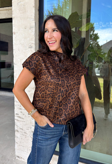 Give your cooler-weather wardrobe a little wild side with this faux suede leopard top from THML. The soft faux suede texture gives the classic animal print a rich seasonal feel that works perfectly as late fall starts turning into winter. A mock neckline adds a polished cold-weather touch, while the short sleeves make it easy to wear on its own or layer underneath a jacket. A keyhole closure at the back finishes the look with a simple detail. 