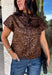 Give your cooler-weather wardrobe a little wild side with this faux suede leopard top from THML. The soft faux suede texture gives the classic animal print a rich seasonal feel that works perfectly as late fall starts turning into winter. A mock neckline adds a polished cold-weather touch, while the short sleeves make it easy to wear on its own or layer underneath a jacket. A keyhole closure at the back finishes the look with a simple detail. 