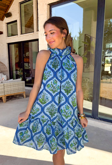 Light, breezy, and made for sunny spring days, this light blue sleeveless dress by Entro is a dreamy warm-weather favorite. Designed with a halter neckline and adjustable tie closure in the back, it offers a flattering fit with an easy, feminine feel. The floral print in soft shades of blue and green adds a fresh pop of color, while the fully lined cotton fabric keeps it comfortable and breathable for all your spring and summer plans.