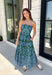 Make a statement this season in this effortlessly beautiful hunter green midi dress! Featuring a light blue abstract print throughout, this strapless silhouette is both timeless and eye-catching. The smocked back bodice offers a comfortable, flattering fit, while the structured zipper closure keeps everything secure. Finished with side pockets and a fully lined design, this cotton midi dress is perfect for fall weddings, dinner dates, and family gatherings.