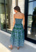 Make a statement this season in this effortlessly beautiful hunter green midi dress! Featuring a light blue abstract print throughout, this strapless silhouette is both timeless and eye-catching. The smocked back bodice offers a comfortable, flattering fit, while the structured zipper closure keeps everything secure. Finished with side pockets and a fully lined design, this cotton midi dress is perfect for fall weddings, dinner dates, and family gatherings.
